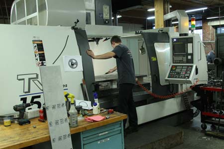 MBM staff member at a machining center